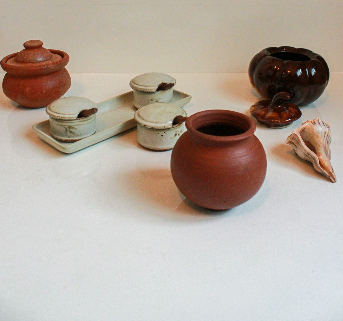 brown and white ceramic jars