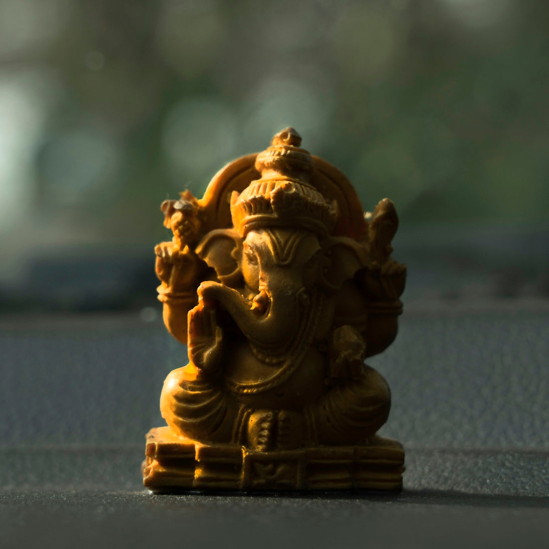 a small statue of a ganesh idol on a table