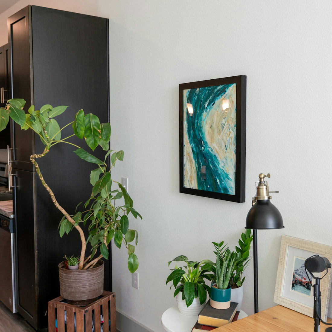 a living room with a painting on the wall