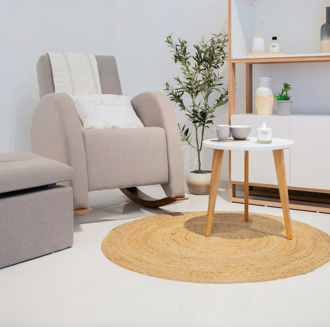 A comfortable rocking chair with an ottoman and side table.