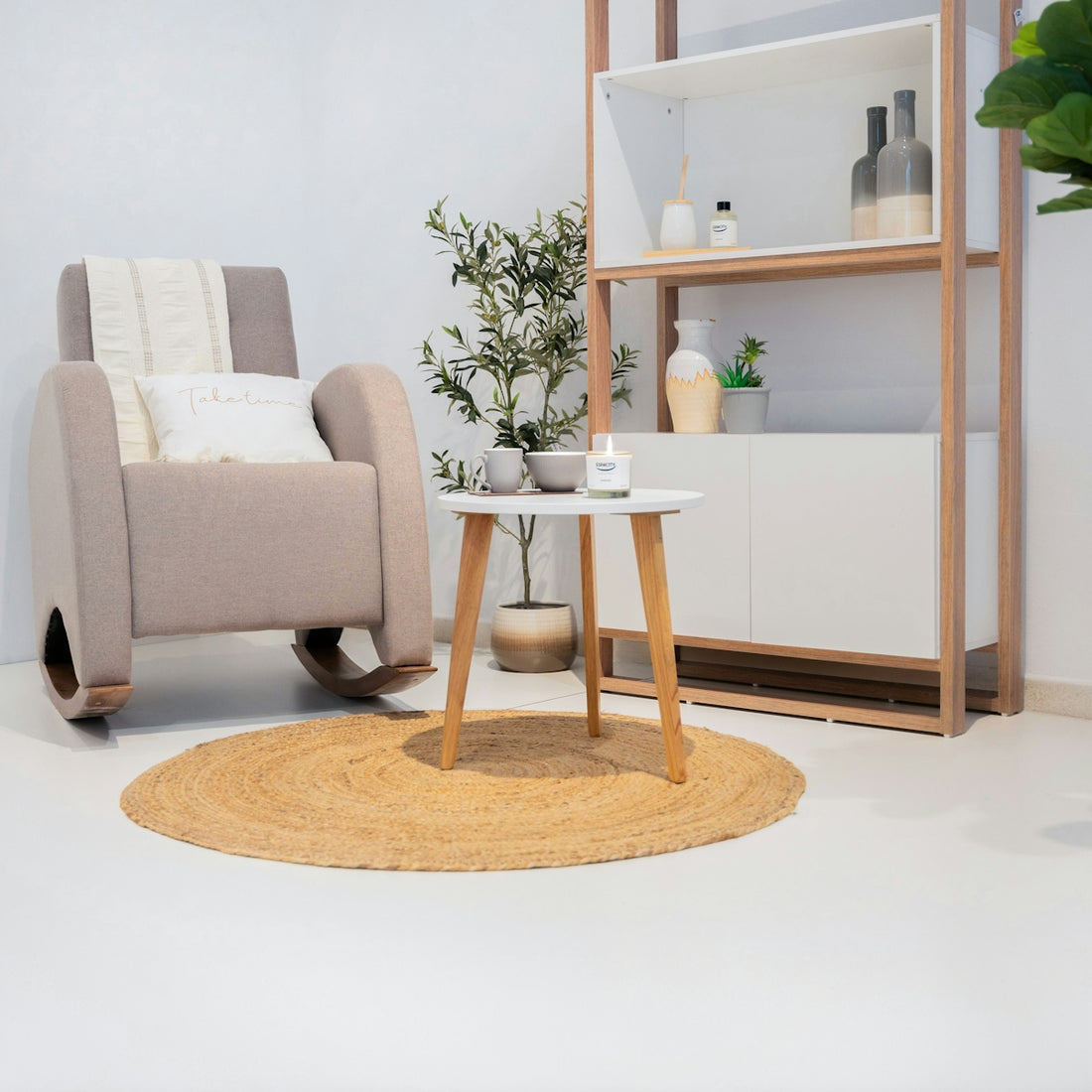 Cozy living room with rocking chair and small table.