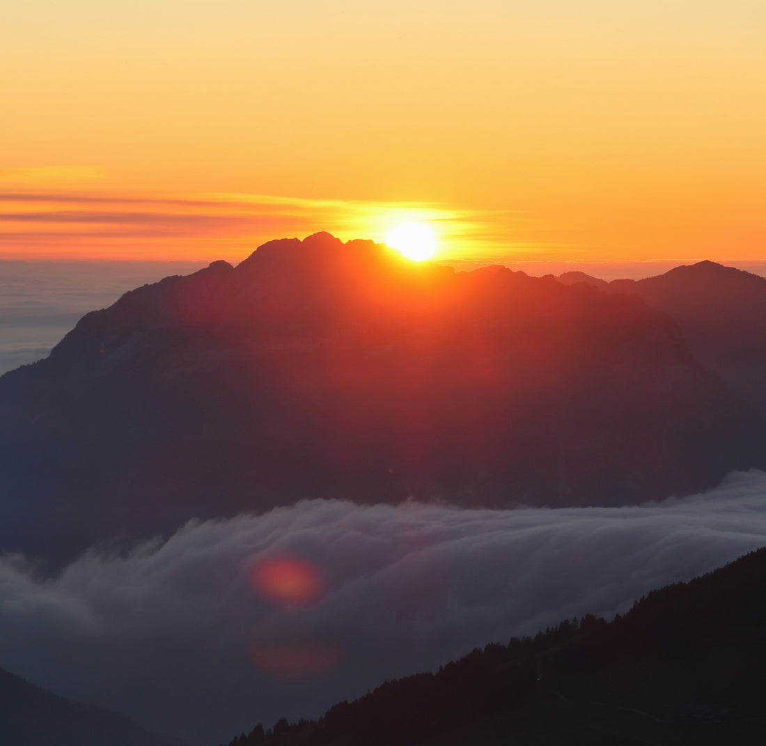 Sunrise over misty mountain peaks
