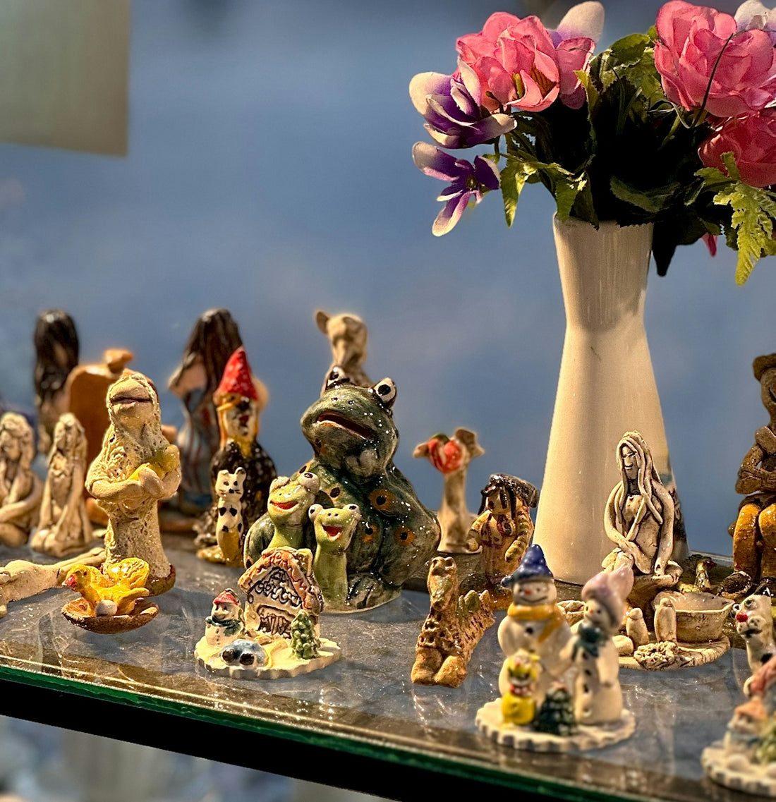Collection of small ceramic figurines on a shelf